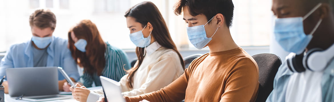 A row of people working while wearing facemasks 