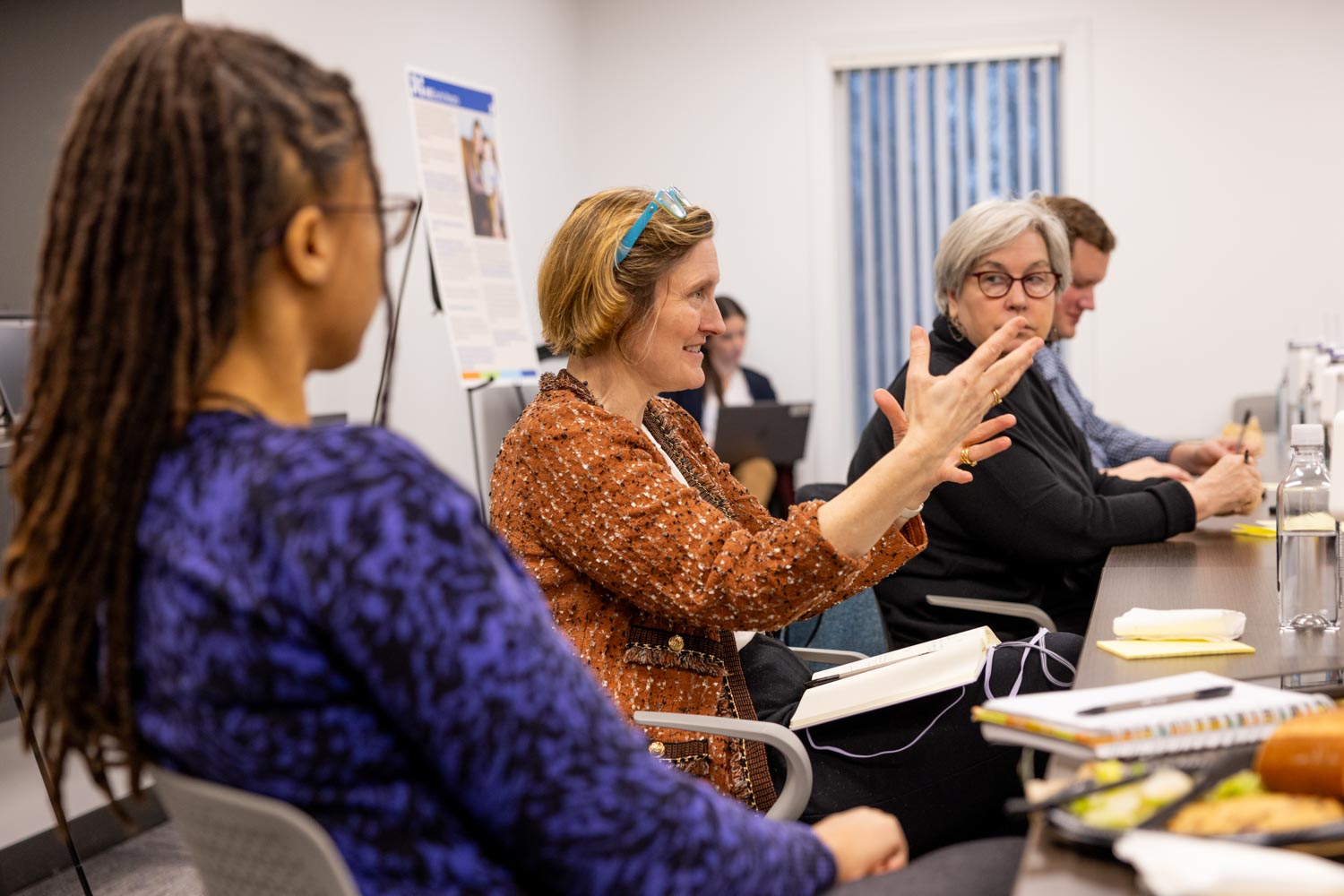 Chicago Fed Research Director Anna Paulson speaks at a conference table with several Detroit-based childcare providers and experts. 