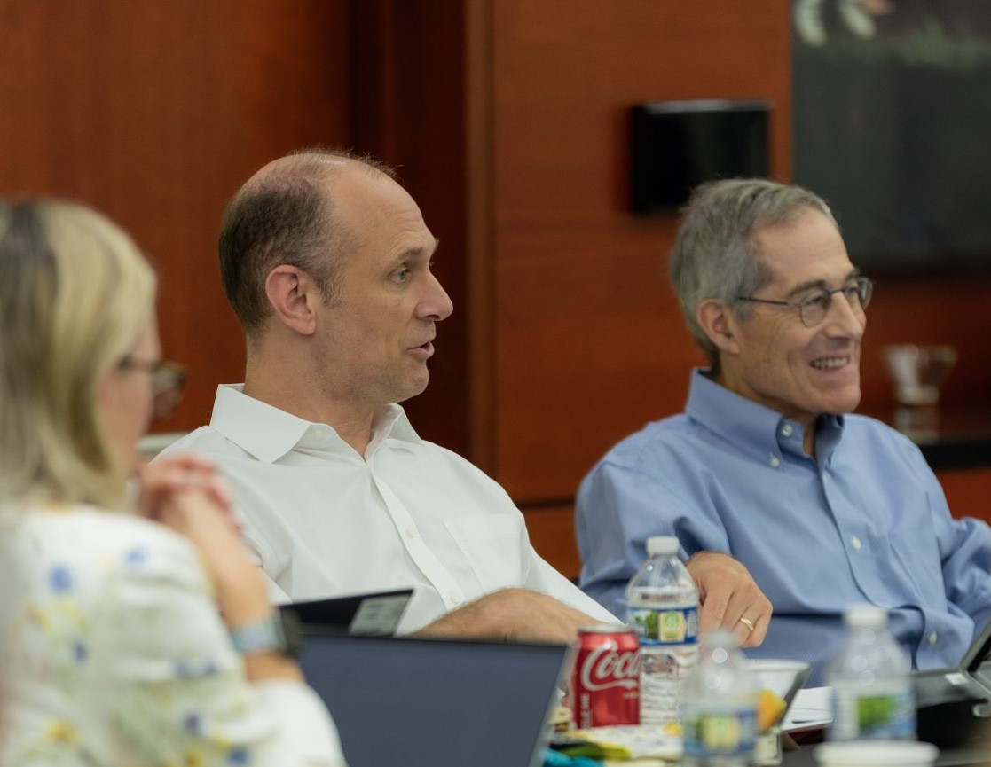 Austan Goolsbee and Spencer Krane seated at a conference table.